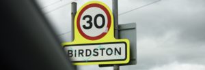 traffic sign displaying area of Birdston, is approaching